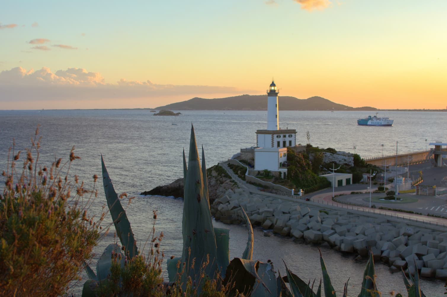 lighthouse in the main port of Ibiza and sunset